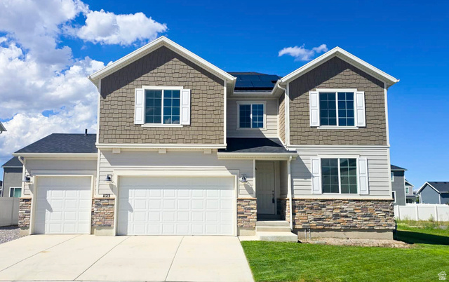 1123 East Postmark Place, Eagle Mountain: two-story home with stone accents, three-car garage, and RV parking